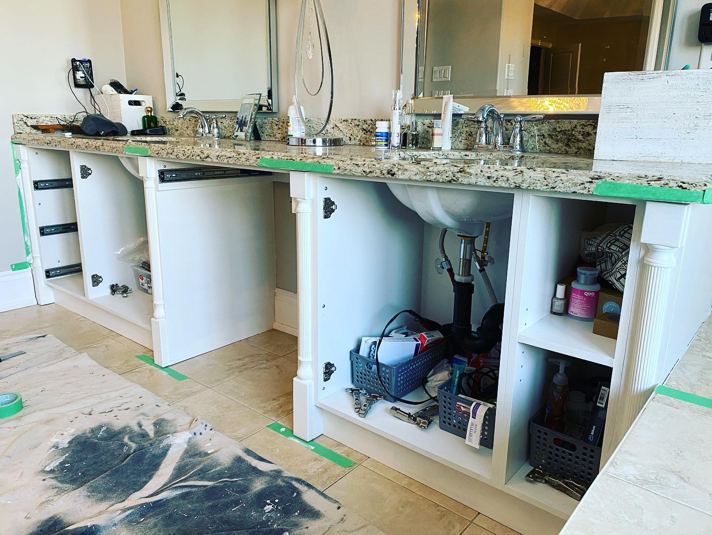 Vanity with doors off and cabinet boxes masked during refinishing