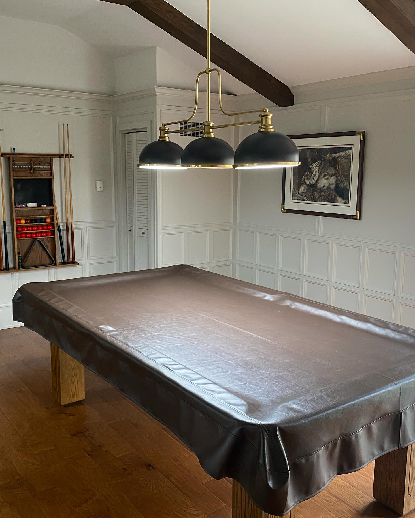 Games room with white wainscoting, dark ceiling beam and pool table