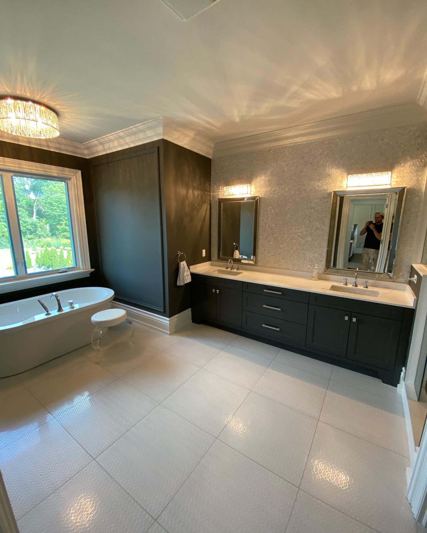 Bathroom with dark vanity, white tile and crown moulding