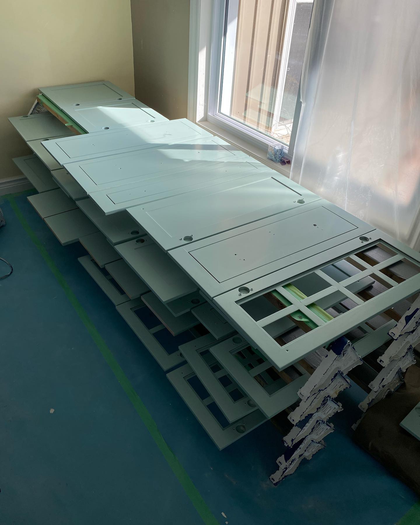Cabinet doors stacked on a drying rack ready for spraying